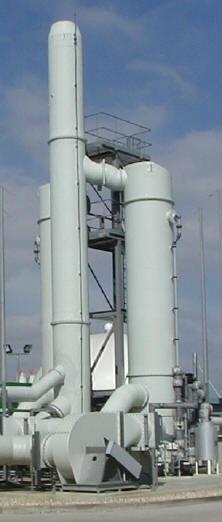 Twin scrubbers and a stack at a sewage sludge treatment facility